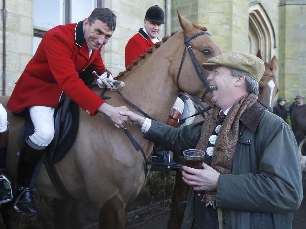 UK Independence Party leader Nigel Farage shakes hands with huntsman Mark Bycroft of the Old Surrey Burstow and West Kent Hunt before they departed from Chiddingstone Castle for the annual Boxing Day hunt in Chiddingstone, south east England